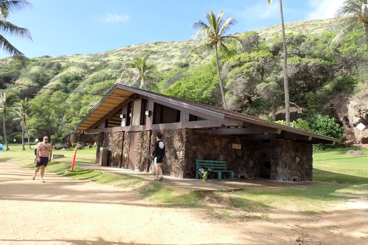 a group of people walking down a dirt road